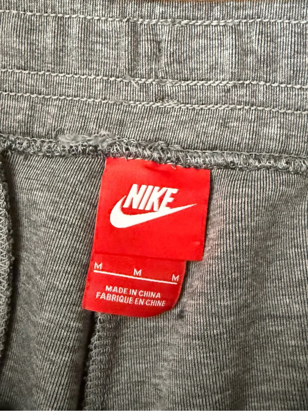 Gray Nike Tech Fleece Joggers with black side stripe